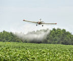 A plane sprays pesticides on crops. Tests Reveal Benefits of Eating Organic Food.