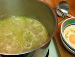 potato and leek soup heats in a pot. Ham can be added if desired.